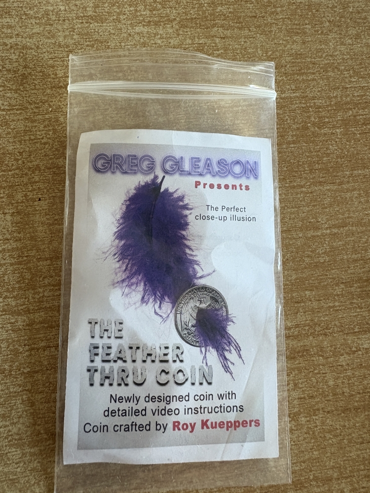 FEATHER THRU COIN by Roy Kueppers