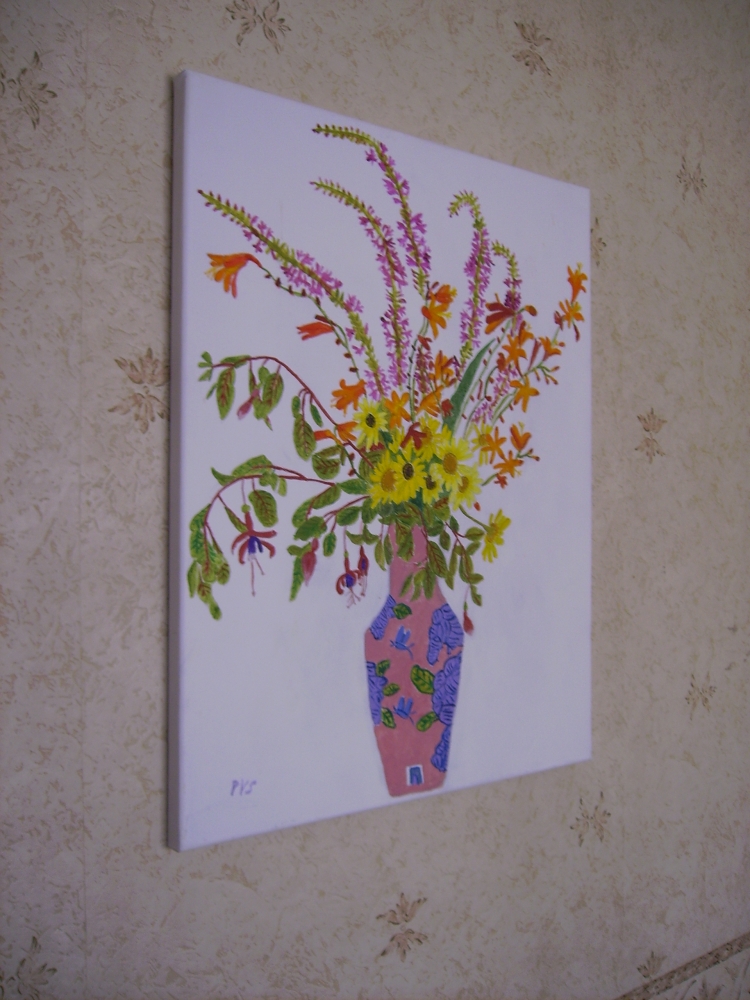 A Mixture of flowers in a two coloured vase.