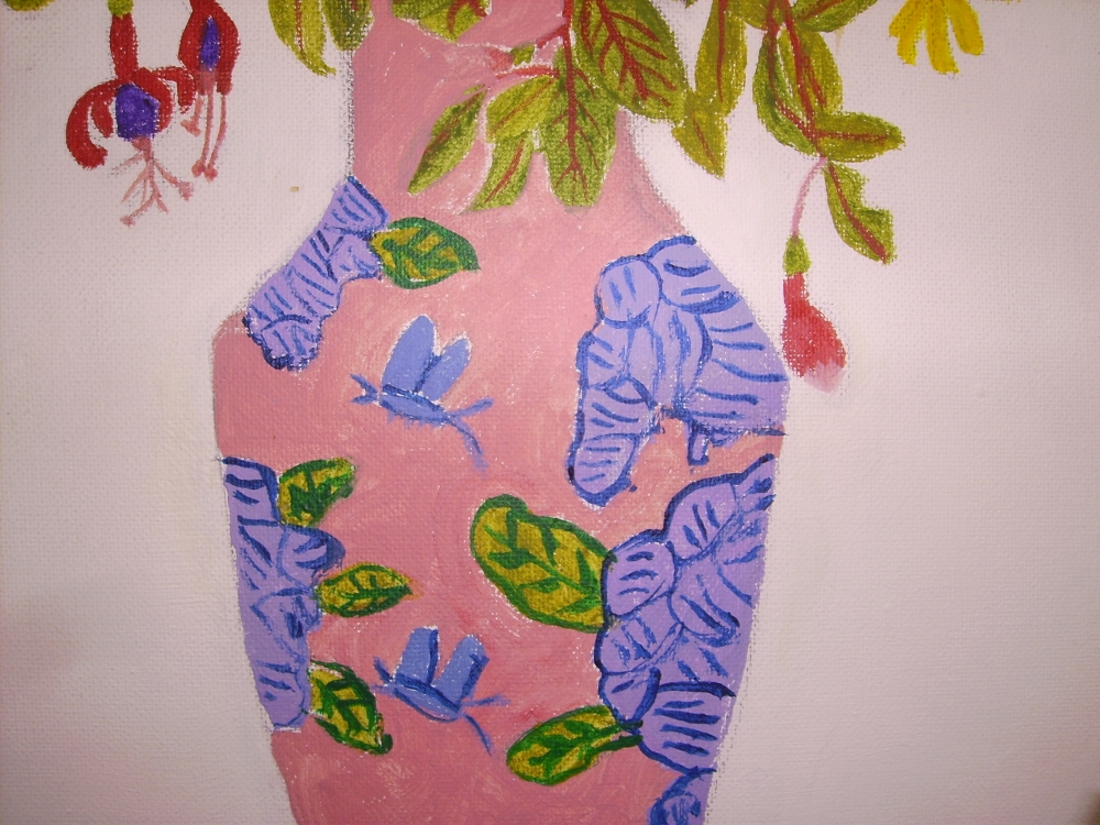 A Mixture of flowers in a two coloured vase.