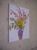 A Mixture of flowers in a two coloured vase.
