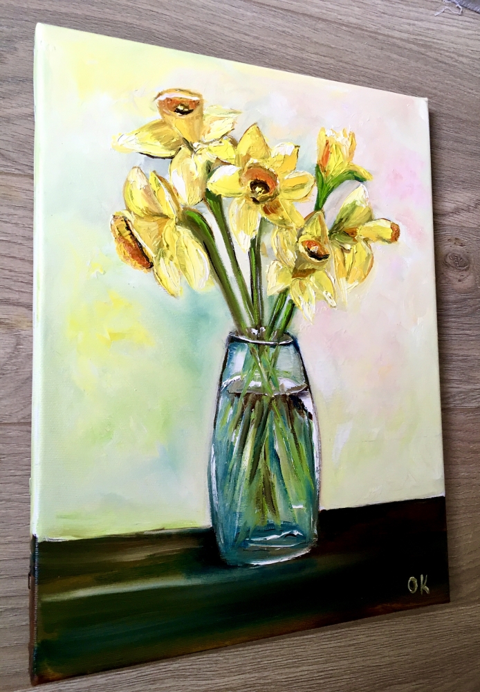 Bouquet of daffodils #3 in a glass on the wooden table. 