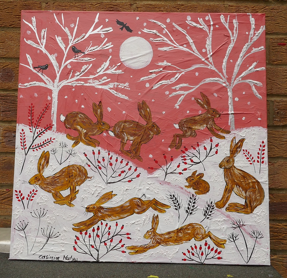 Hares Running in Snow in a Pink Sunset