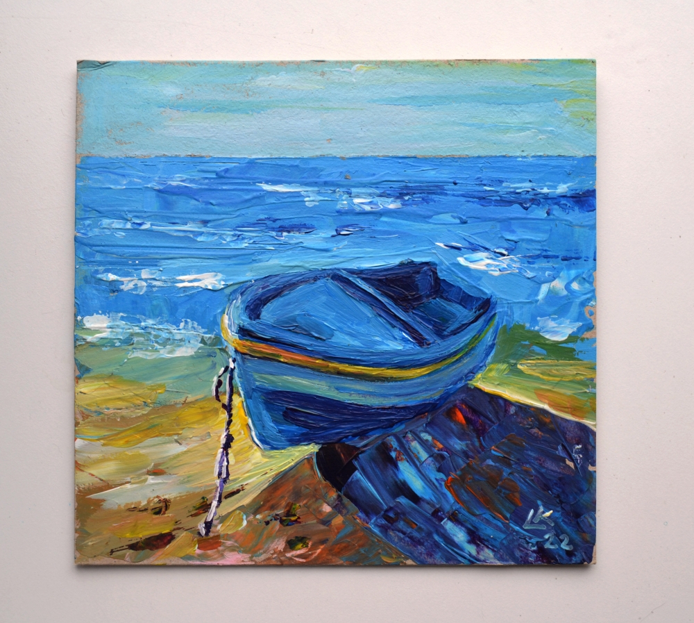 Blue boat on seashore