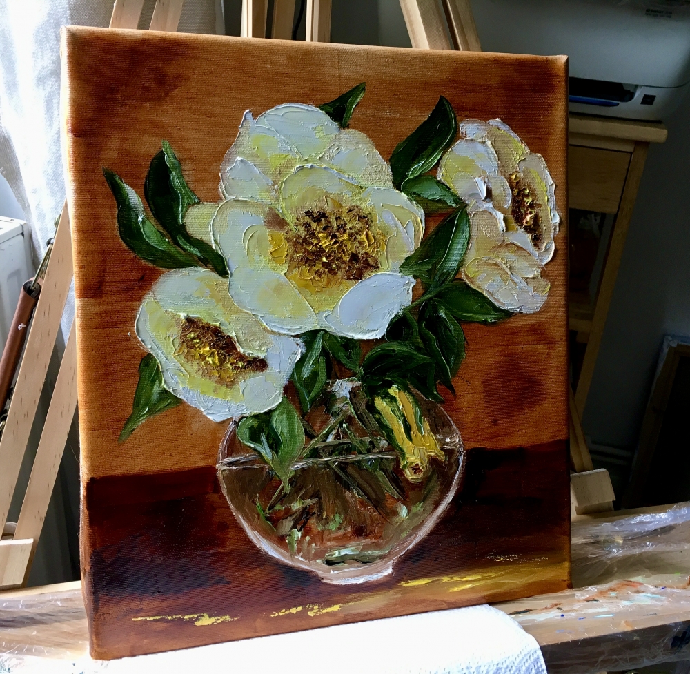 Bouquet of wild yellow roses in a vase on wooden table