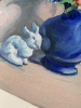 Blue vase with flowers and rabbit.