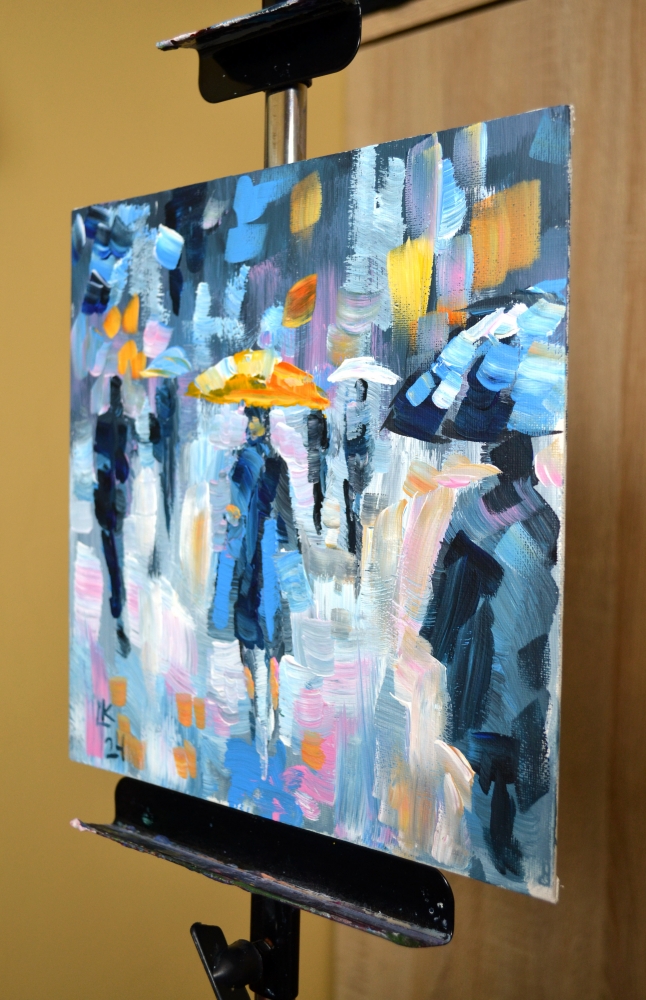 People with Umbrellas in the Rain on a Colorful City Street