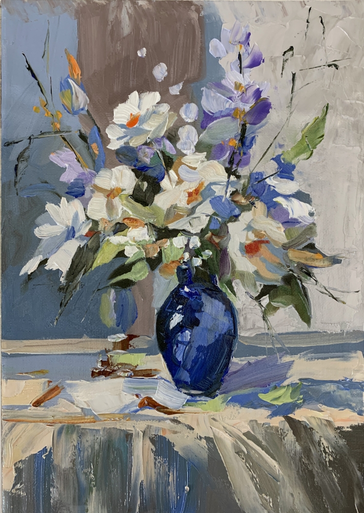 White flowers in a blue vase.