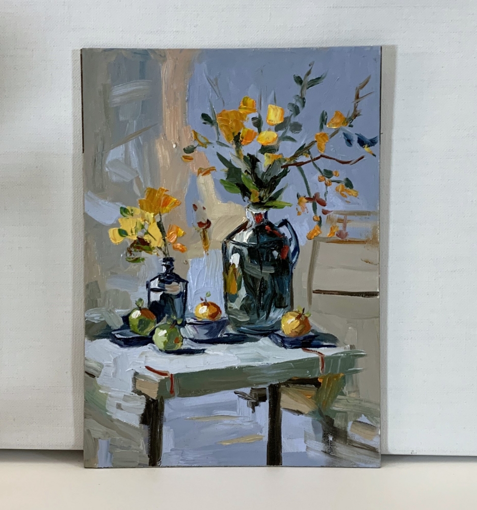 Yellow flowers in a black vase.