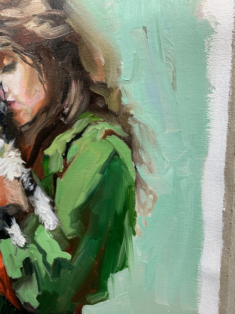 Girl in green dress with cat painting.