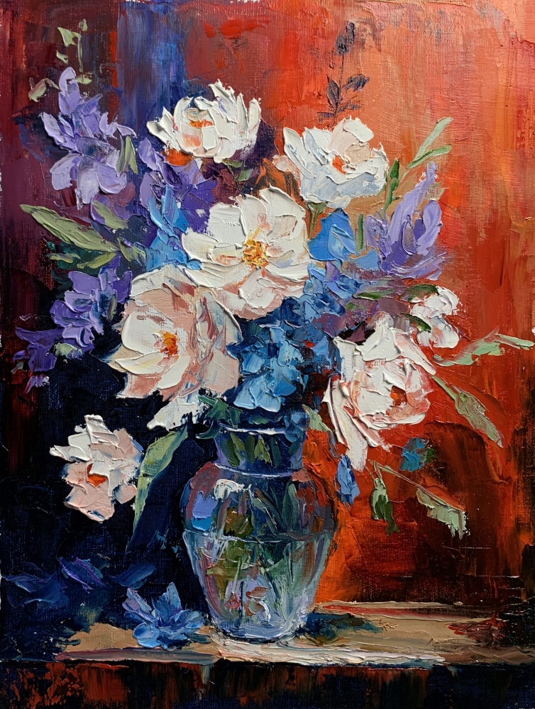 Bouquet of White flowers in a blue vase on red. 