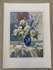 White flowers in a blue vase.