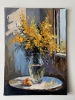 Bouquet of mimosa in a transparent vase by the window. Framed