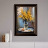 Bouquet of mimosa in a transparent vase by the window. Framed