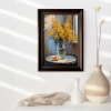 Bouquet of mimosa in a transparent vase by the window. Framed