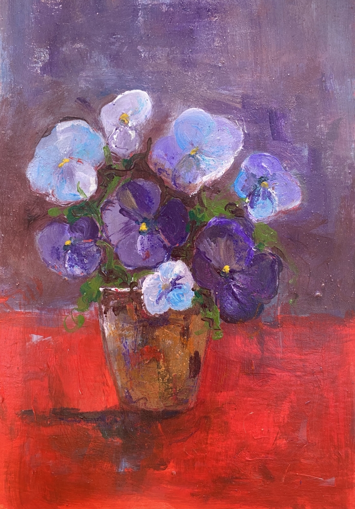 Vase of purple pansies