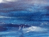 Dolphin cutting through the ocean as sunrise begins to emerge.