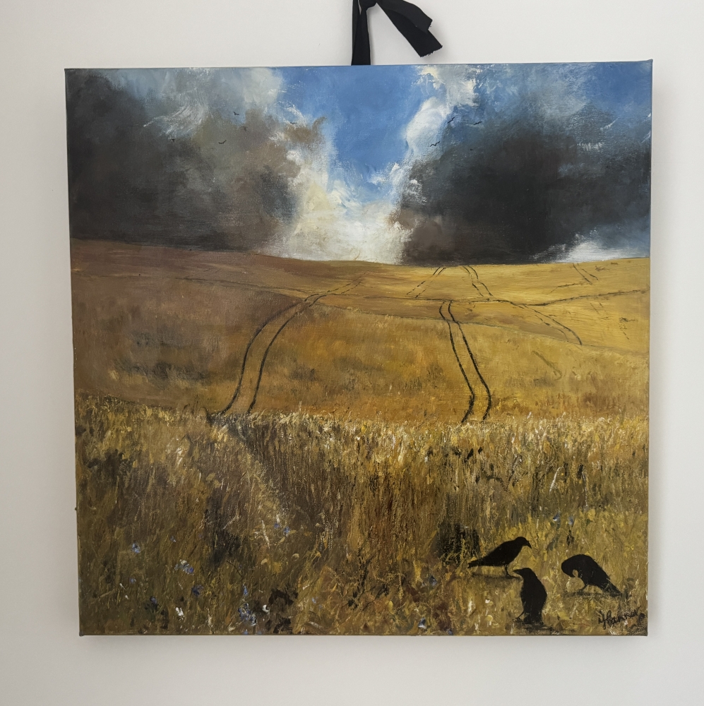 Stormy skies over cornfield with crows