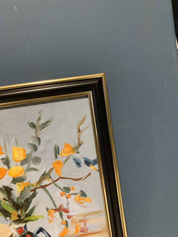 Yellow flowers in a black vase.