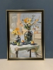 Yellow flowers in a black vase.