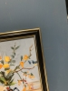 Yellow flowers in a black vase.