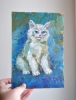 White Kitten on a Blue Background