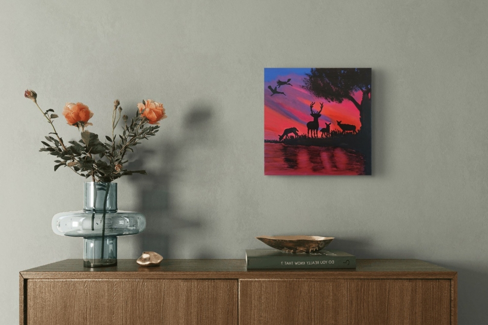Deer by the lake at sunset