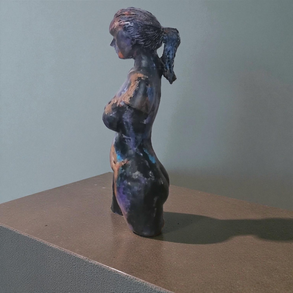 Woman, sculpture made in clay and painted with an abstract pattern