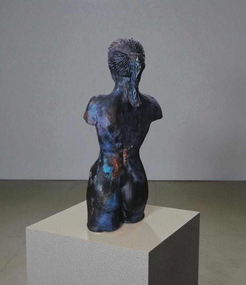 Woman, sculpture made in clay and painted with an abstract pattern