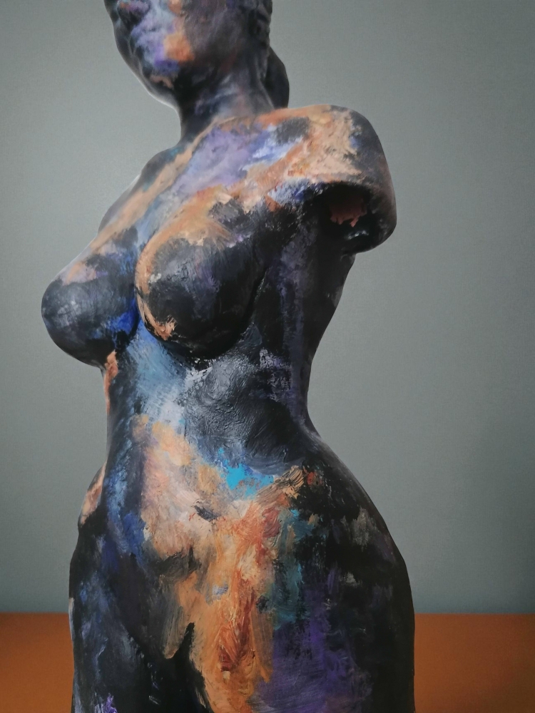 Woman, sculpture made in clay and painted with an abstract pattern