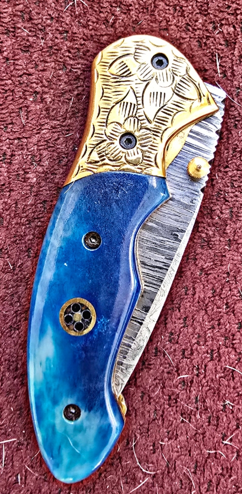 Damascus hand-made hand forged folding knives. Bone scales,  hand engraved bolsters.  Ambidextrous open.