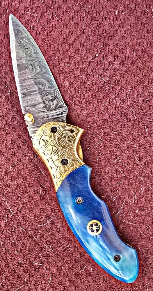 Damascus hand-made hand forged folding knives. Bone scales,  hand engraved bolsters.  Ambidextrous open.