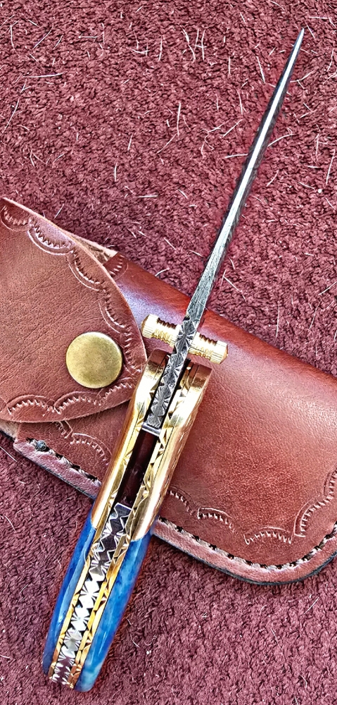 Damascus hand-made hand forged folding knives. Bone scales,  hand engraved bolsters.  Ambidextrous open.