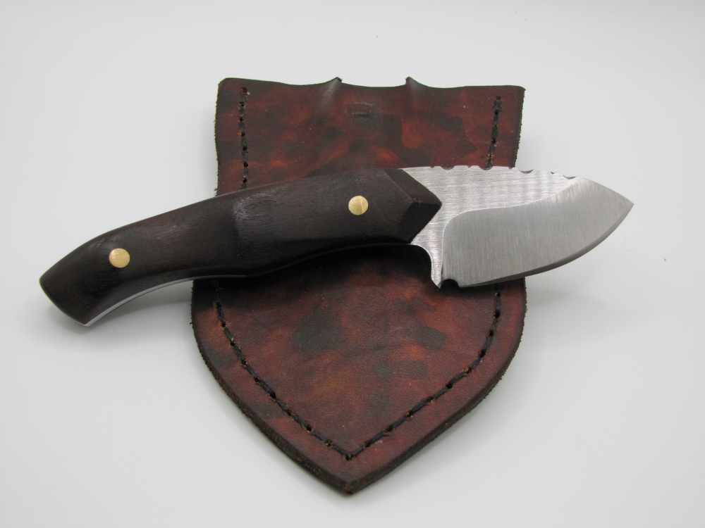 1095 high carbon steel caping knife with a drop point with natural wood handles