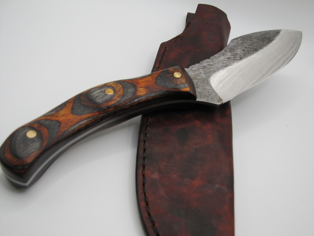 1095 high carbon steel camp knife with a walnut and black dymalux handle