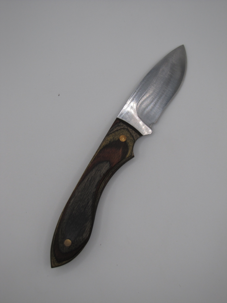 1095 high carbon steel drop point skinner with black olive walnut camo dymalux handle