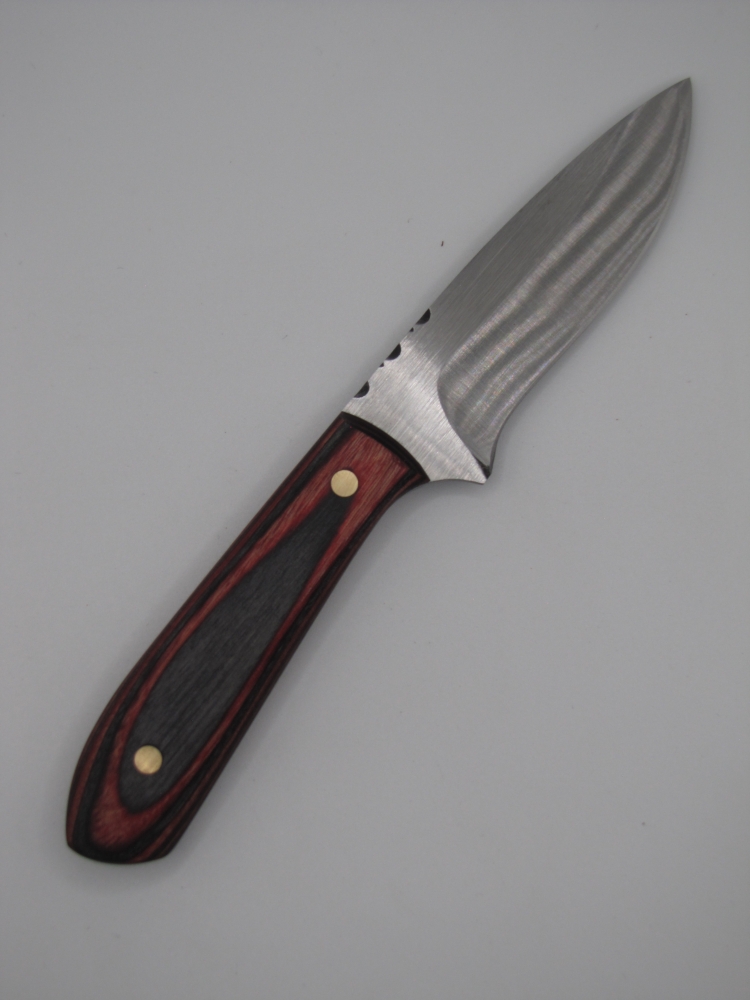 drop point utility knife 1095 high carbon steel with a red and back dymalux handle