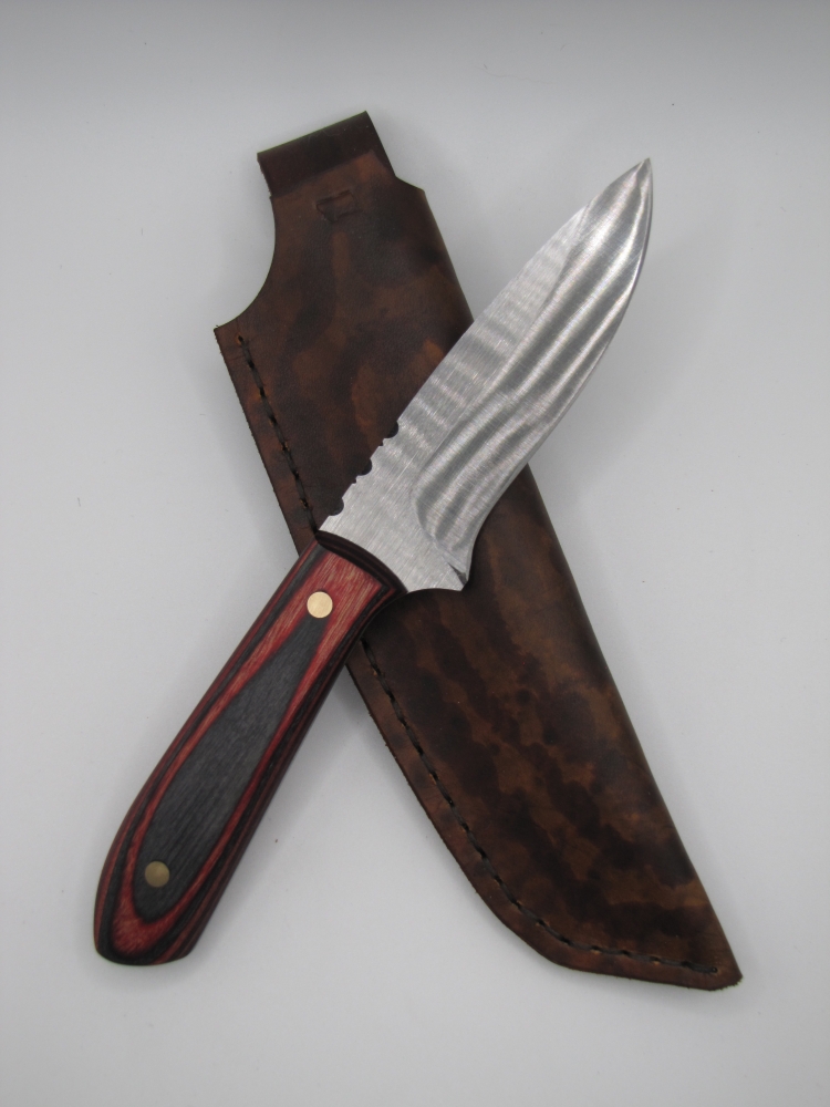 drop point utility knife 1095 high carbon steel with a red and back dymalux handle