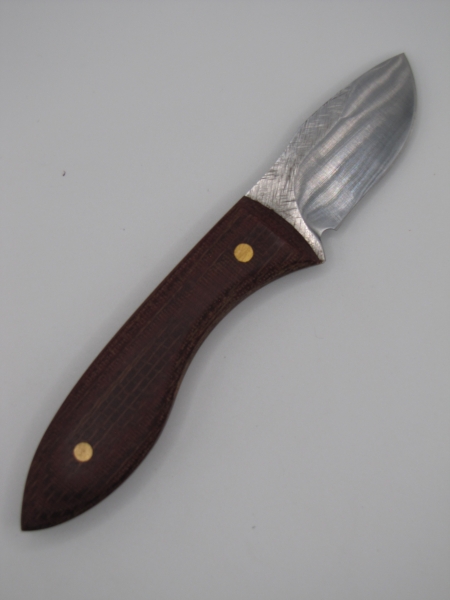 1095 high carbon steel drop point skinning blade with a red micarda handle 