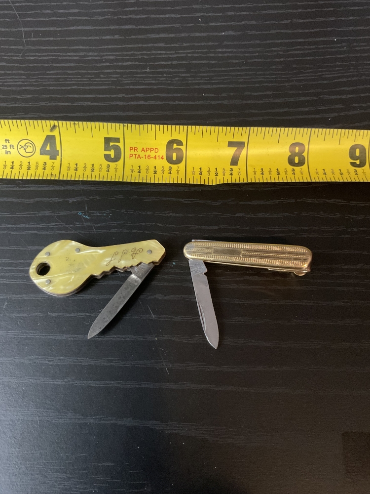 Two vintage souvenir folding knives a key and a tie clip very small