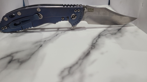 Hinderer XM-24 Bowie. Stonewashed blade with Blue titanium and Black G10 Scales.
