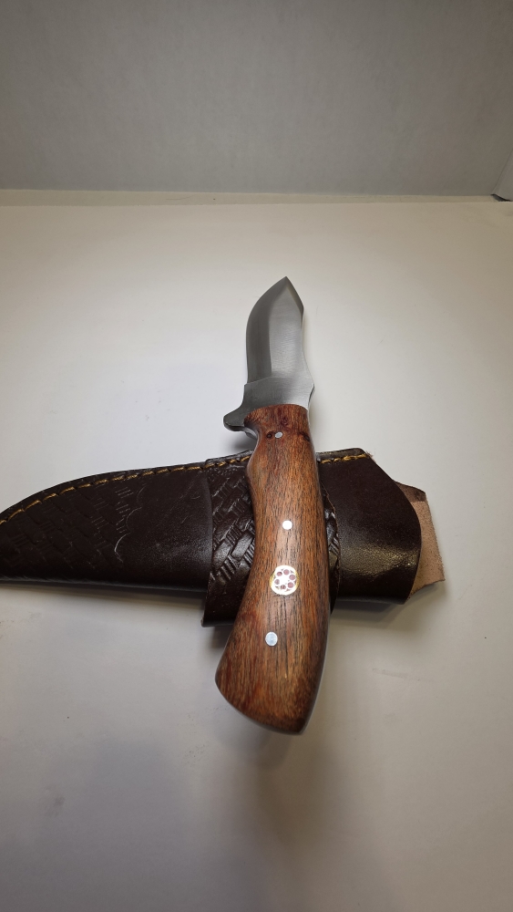 A fixed blade would handle D2 steel or 440C. Steel