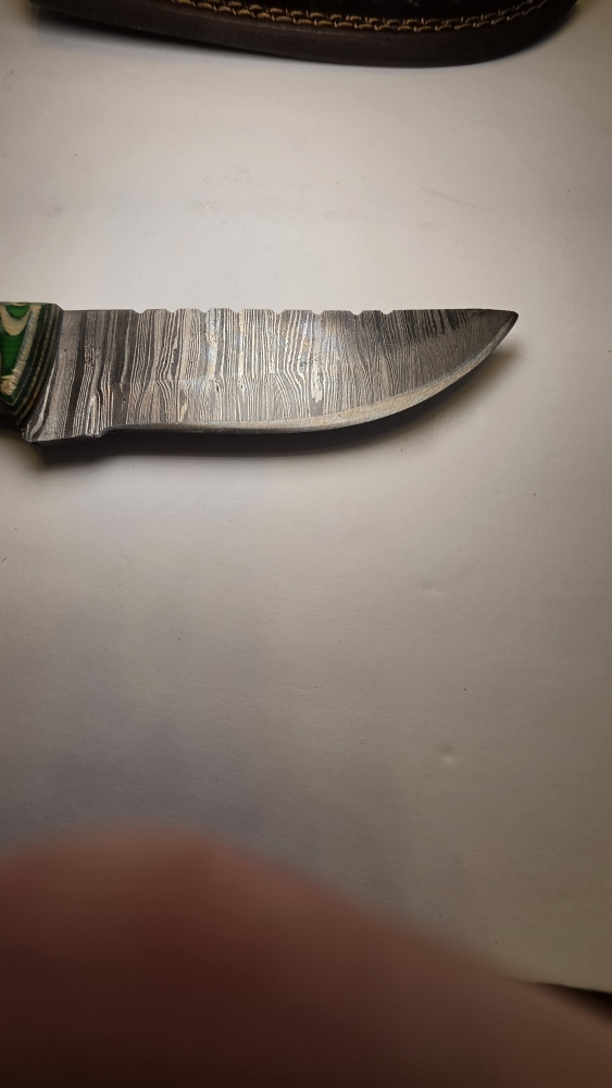 Damascus blade with a wood handle