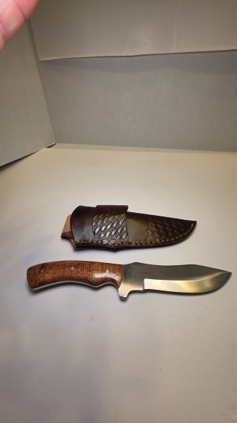 A fixed blade would handle D2 steel or 440C. Steel