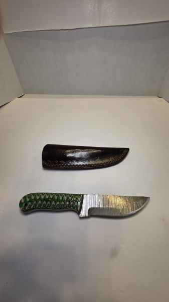 Damascus blade with a wood handle