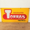 Chapa esmaltada de doble cara de Chocolates Torras, 1950 - 1959