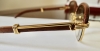 Gafas Cartier modelo Malmaison en madera de palisandro y metal dorado, con estuche y tarjeta de garantía, Francia, finales del siglo XX