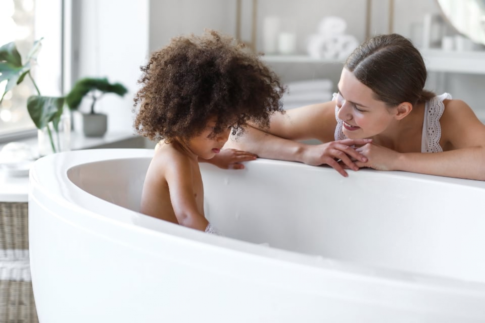 A parent bathing a baby.